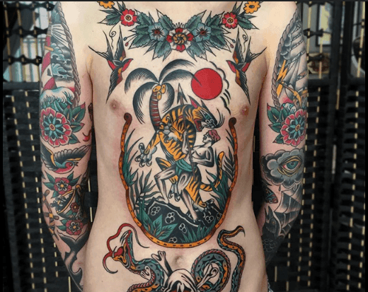 Person with colorful tiger and nature-themed tattoos covering the torso and arms.