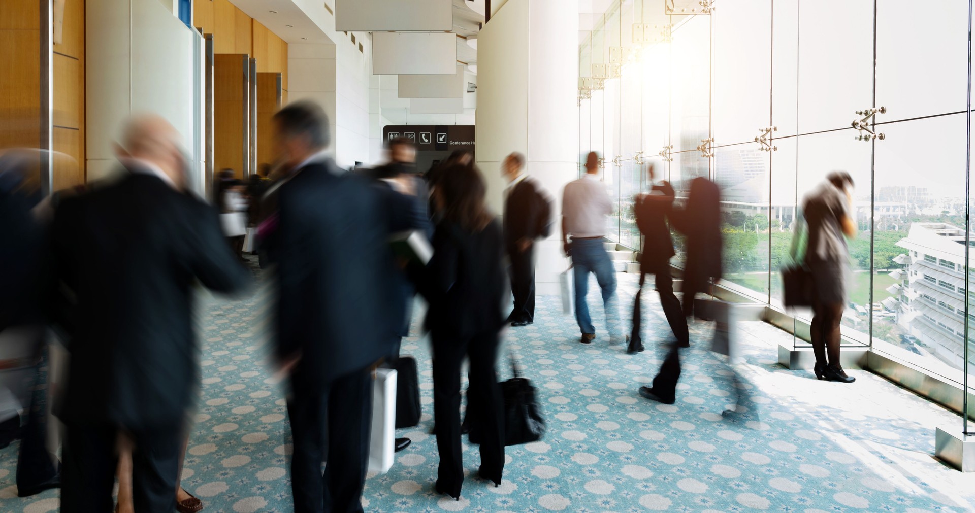 Business people talking and rushing in the lobby